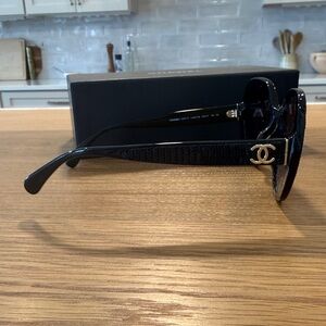CHANEL Black Sunglasses with Gold Accent and black sequins on side.